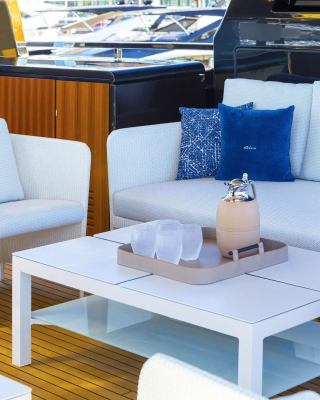 Superyacht exterior dining area with valet tray and glassware