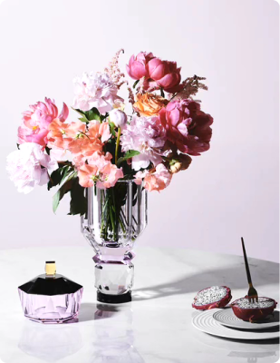 Pink glass vase with flowers and accessories